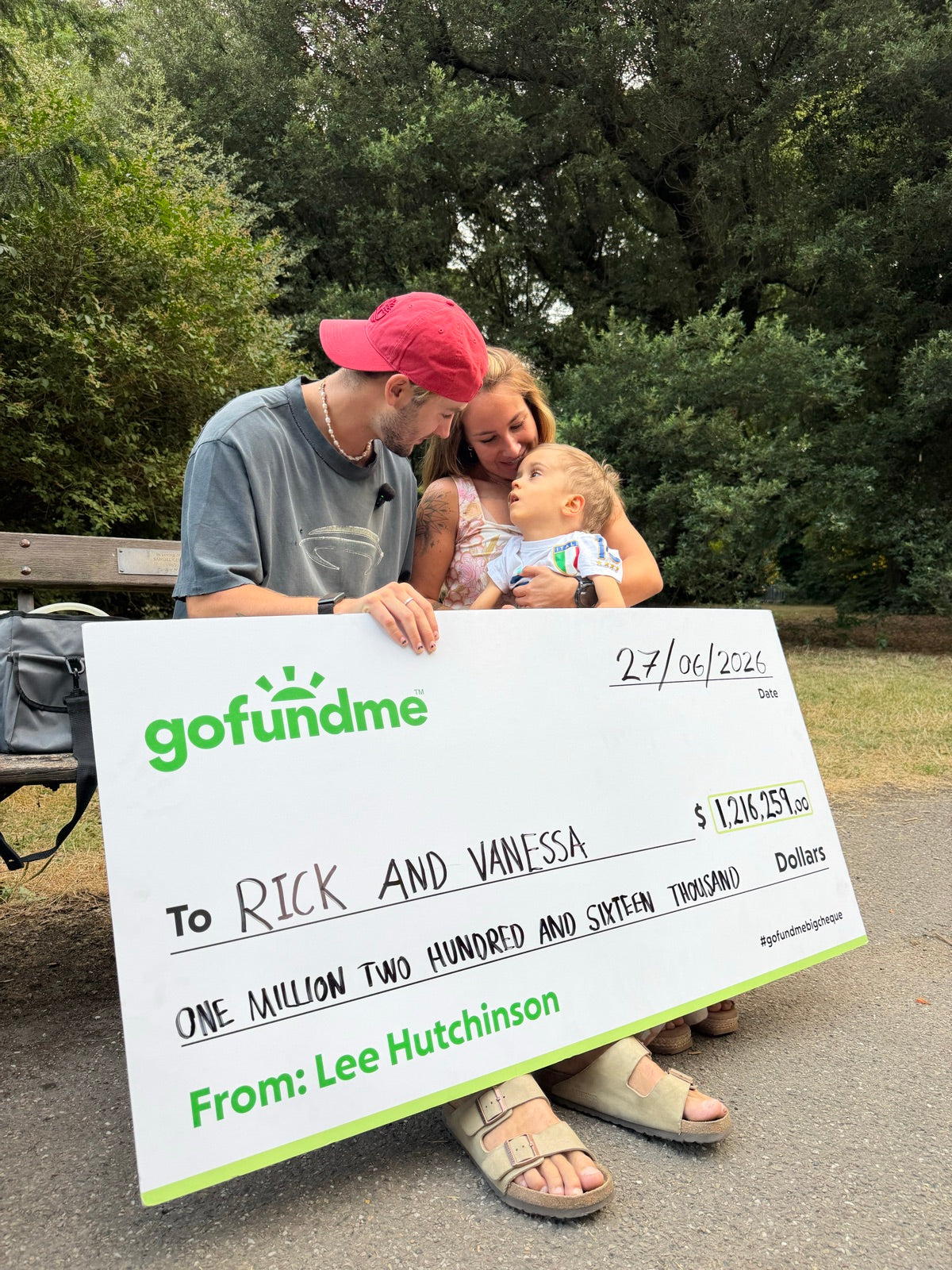 Lee with Rick and Vanessa holding their fundraiser cheque