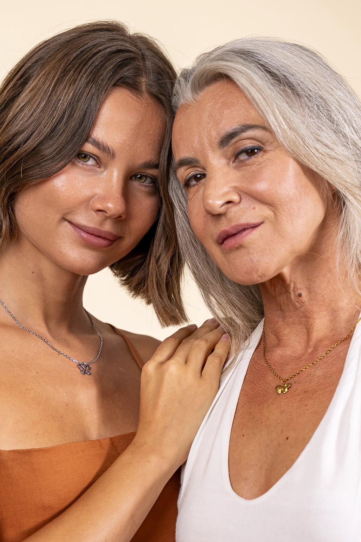 Women wearing Butterfly necklaces in gold